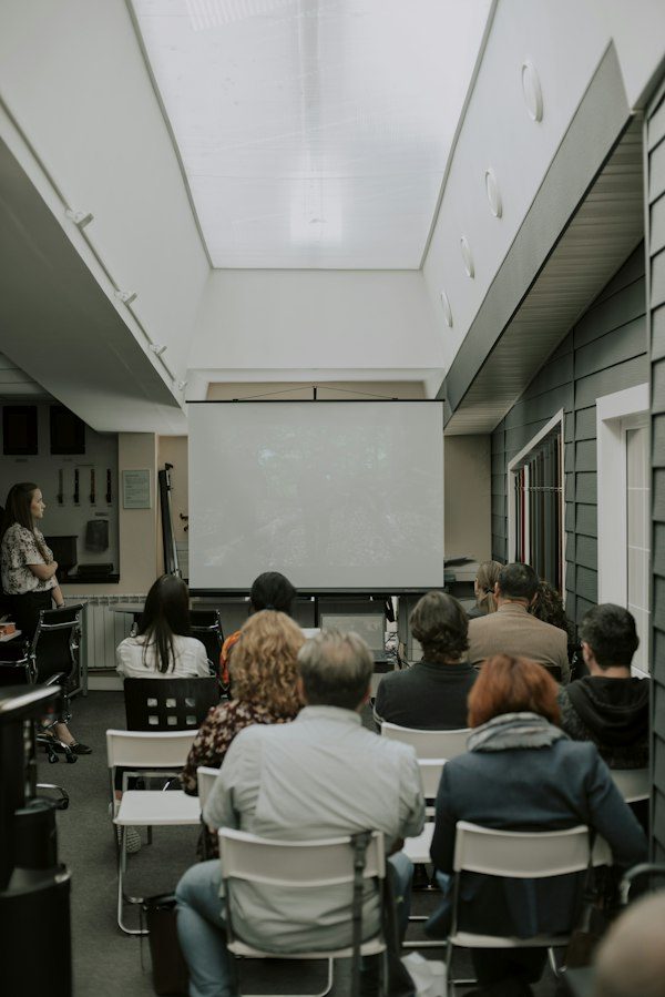 A seated audience listening in a hall